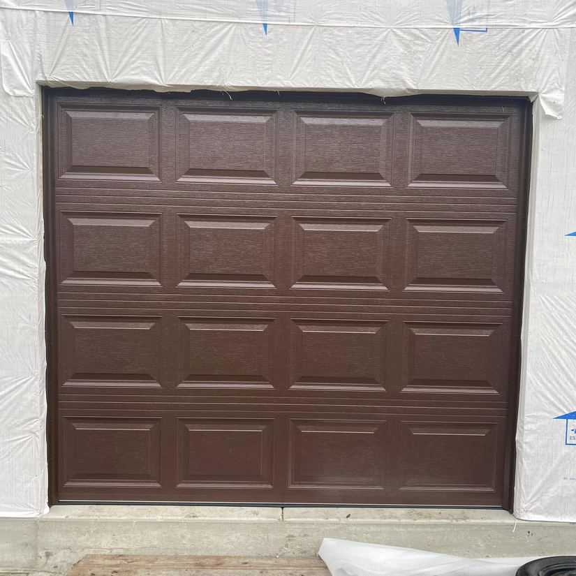 Garage door wrapped in house wrap during install, Chicago